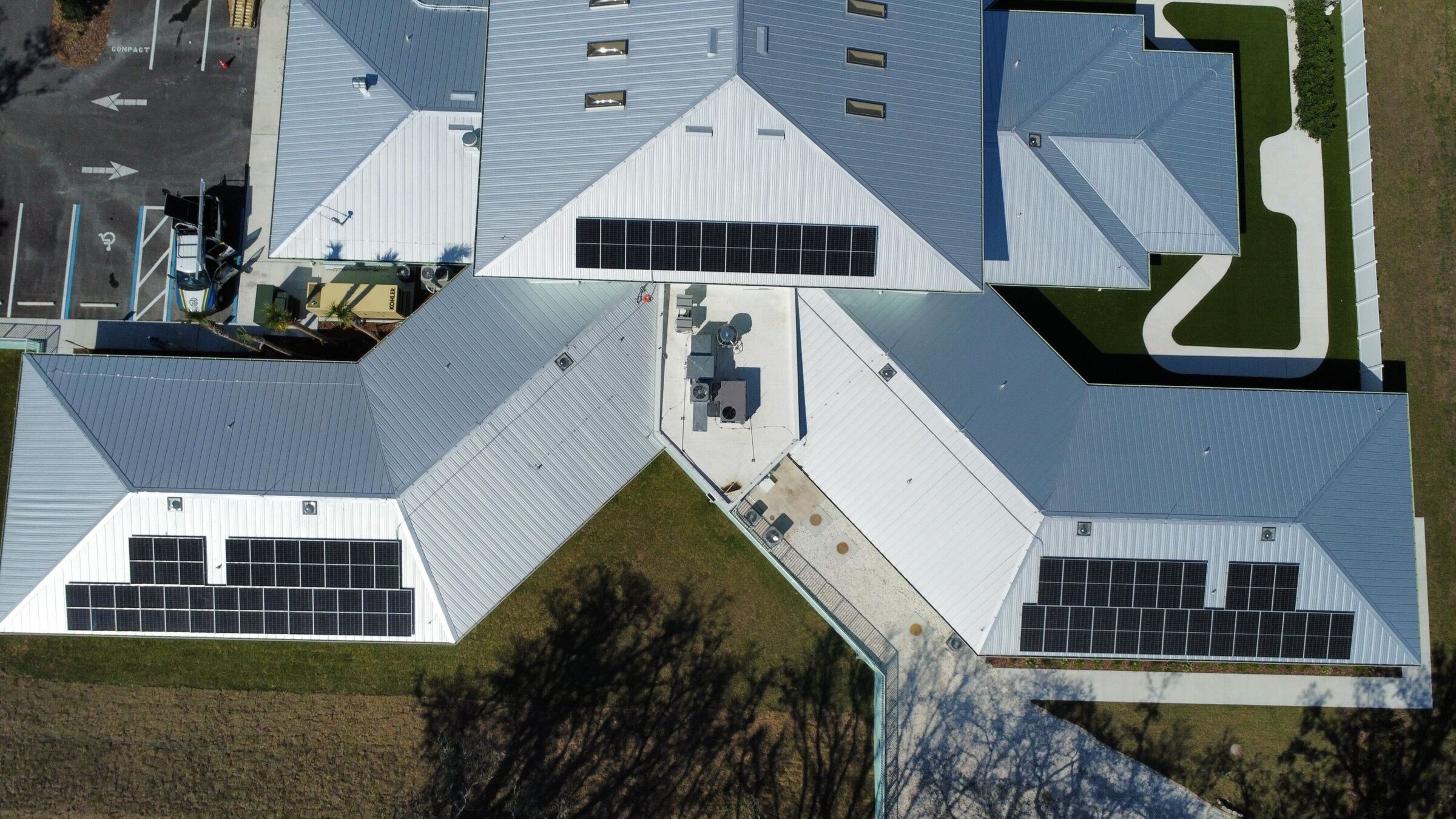 Overhead view of solar panels on the metal roof wings of an assisted living center in Florida