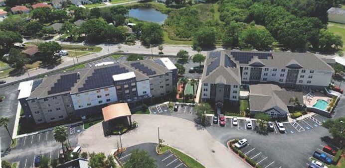 Aerial view of two neighboring Marriott hotels in Oldsmar, Florida, both with rooftop solar