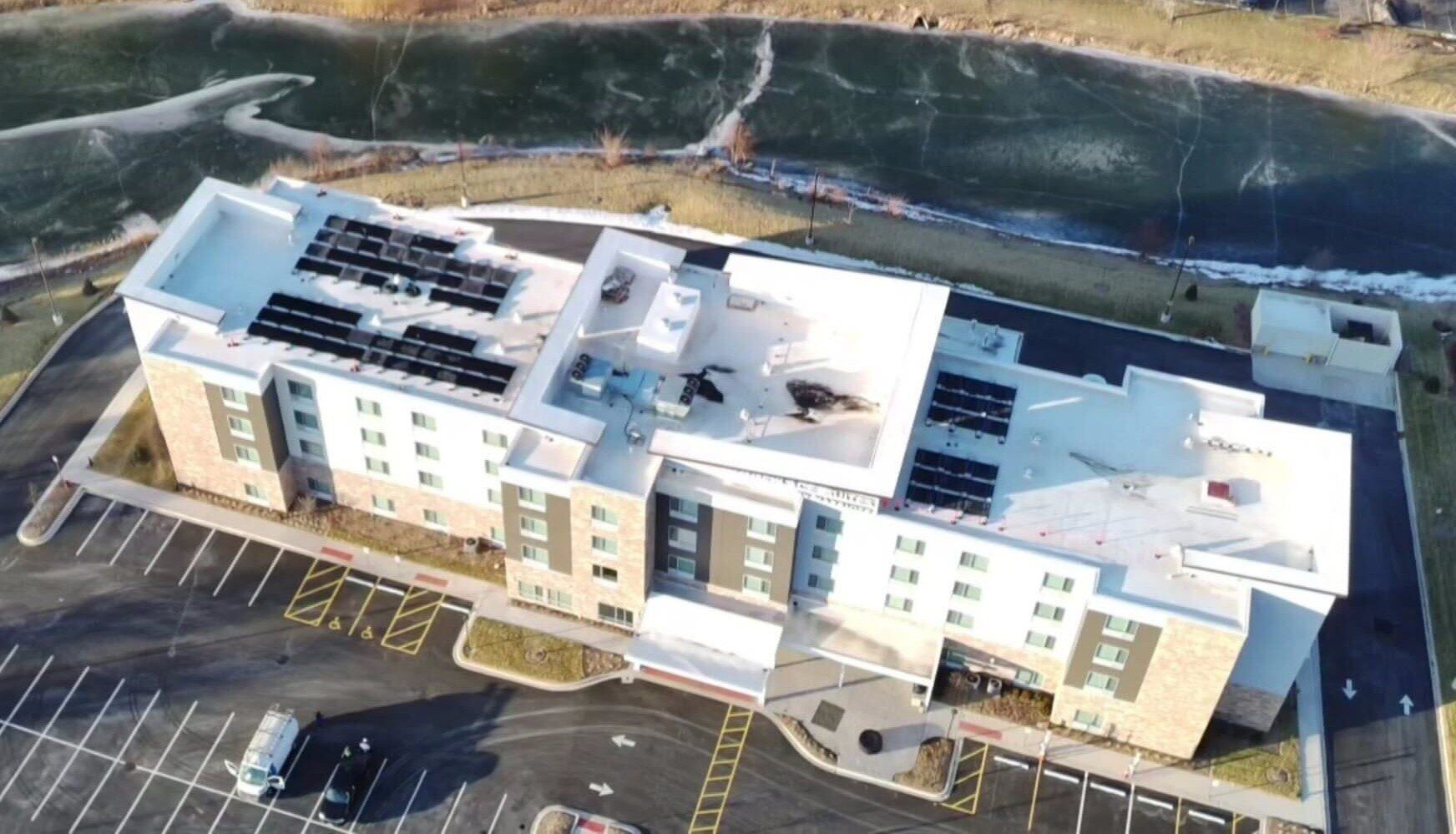 Aerial view of TownePlace Suites in Romeoville, Illinois with solar panels on the roof